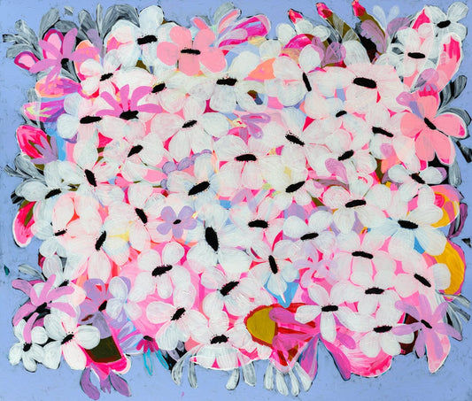 Colorful bouquet of artificial flowers with pink, white, and multicolor petals on a blue background